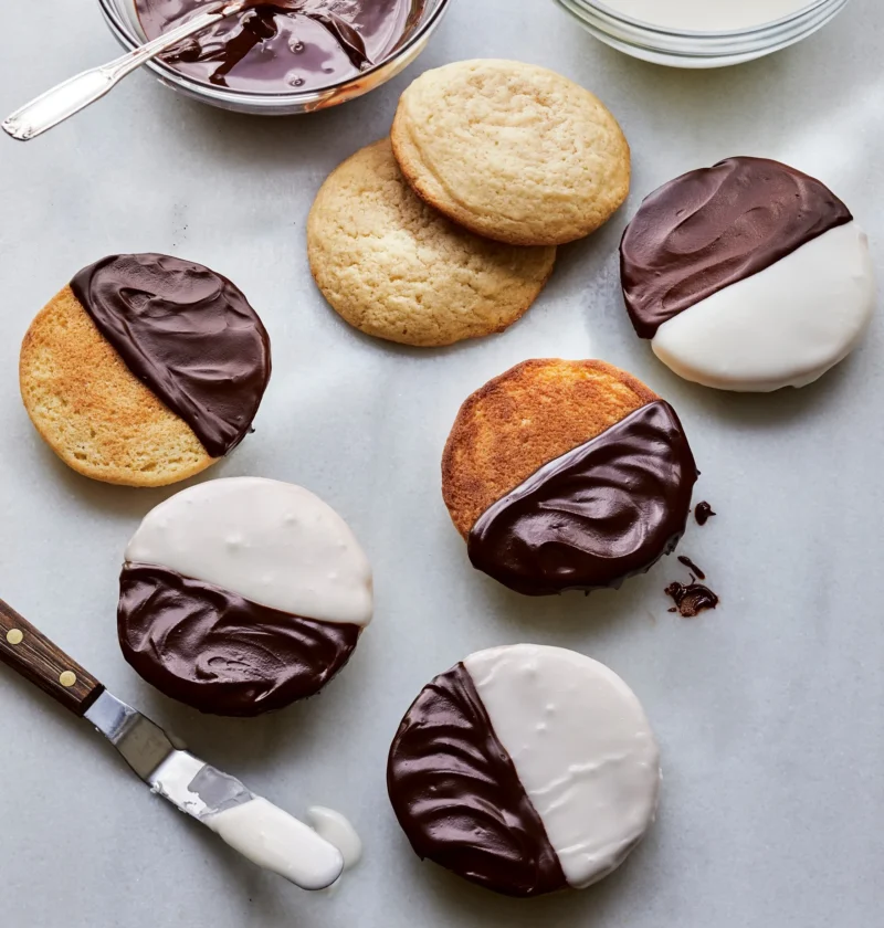 Ina Garten black and white cookies with half chocolate and half vanilla glaze on a wire rack