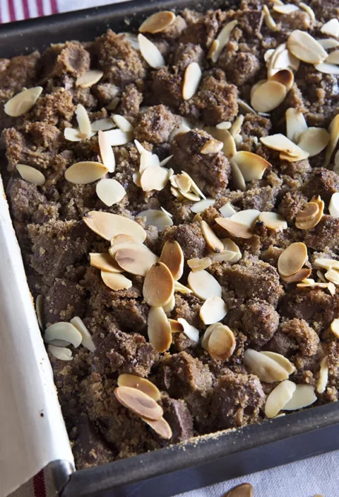 Chocolate banana crumb cake with bittersweet chocolate streusel and sliced almonds in a square baking pan