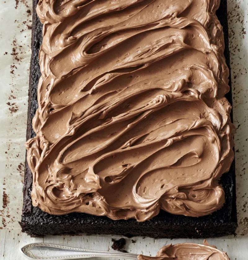 Ina Garten chocolate buttercream frosting swirled on top of chocolate cupcakes