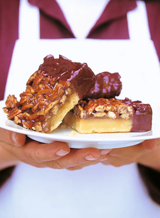 Ina Garten pecan squares with golden brown pecan topping on a buttery shortbread crust, cut into bars