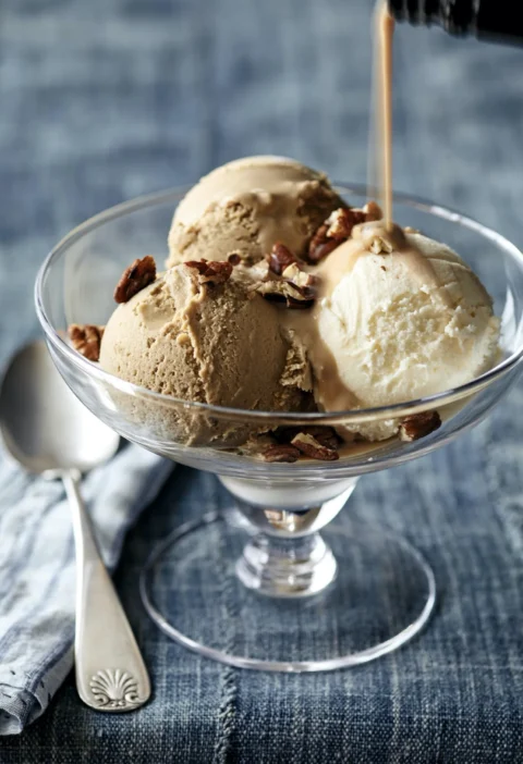 Bowls of vanilla ice cream and coffee sorbet topped with Bailey's Irish Cream and toasted pecans for Ina Garten Bailey's and Cream dessert