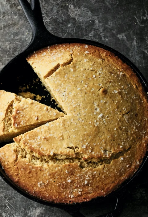 Ina Garten brown butter skillet cornbread in a cast-iron pan, golden on top with flaked sea salt