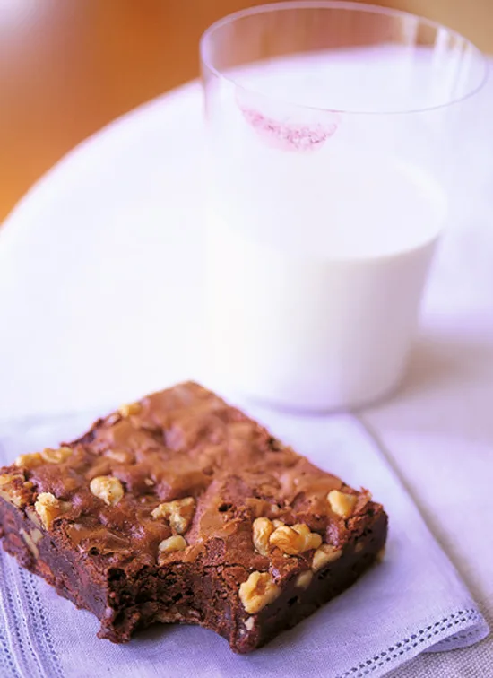 Dense fudgy ina garten outrageous brownies on a plate, loaded with chocolate chips and walnuts