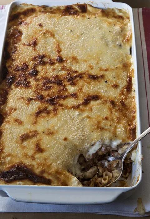 Ina Garten pastitsio in a baking dish with golden bubbly Parmesan béchamel topping
