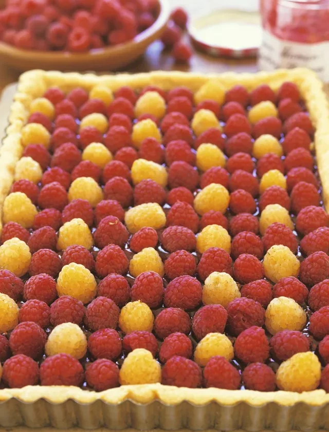 Ina Garten raspberry tart with fresh raspberries arranged in rows on a golden shortbread crust