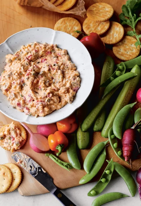Spicy pimento cheese spread with sharp white Cheddar, pickled jalapeños, and Sriracha in a bowl with crackers, Ina Garten spicy pimento cheese spread recipe