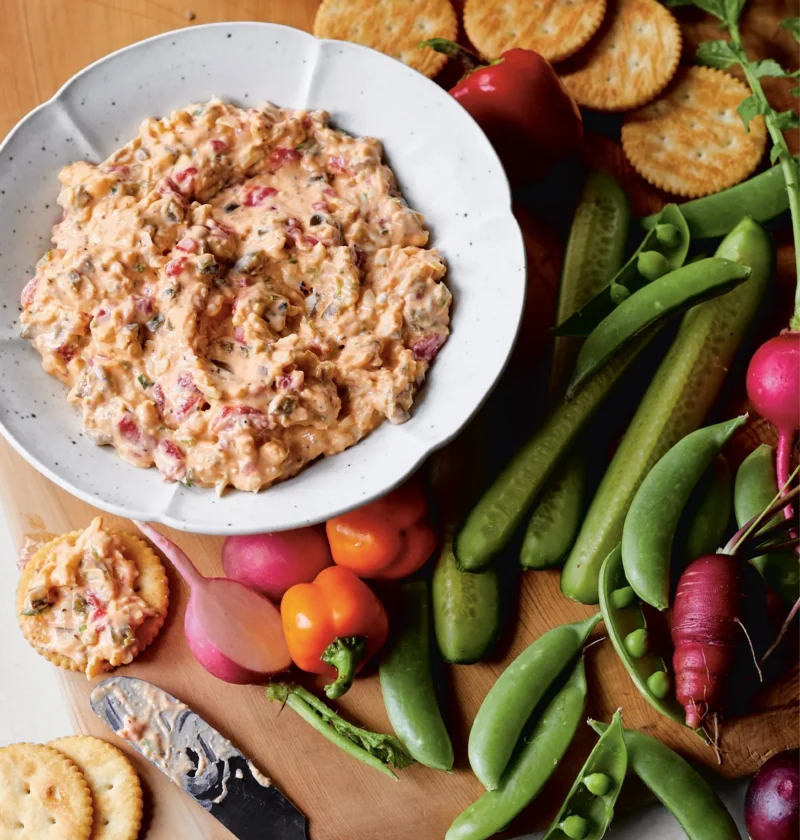 Spicy pimento cheese spread with sharp white Cheddar, pickled jalapeños, and Sriracha in a bowl with crackers, Ina Garten spicy pimento cheese spread recipe