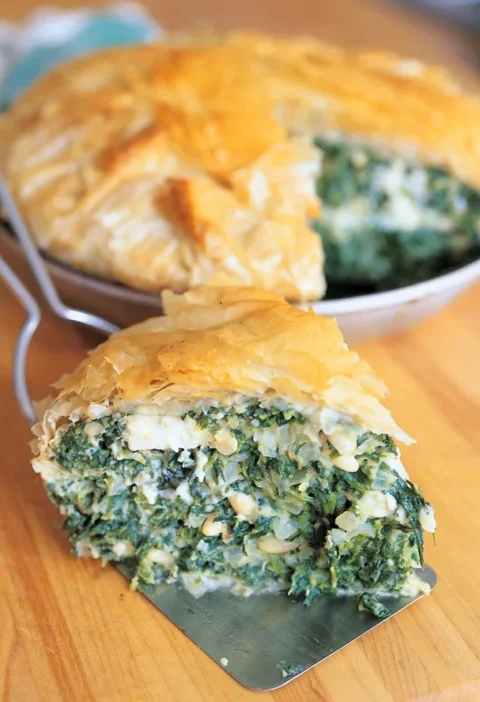 Golden phyllo-wrapped ina garten spinach pie filled with feta, pine nuts, and spinach in an 8-inch pan
