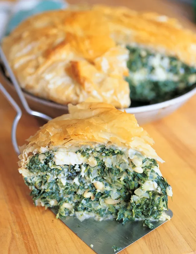 Golden phyllo-wrapped ina garten spinach pie filled with feta, pine nuts, and spinach in an 8-inch pan