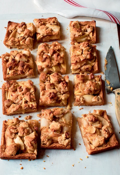 Ina Garten apple pie bars cut into squares with a golden walnut crumble topping and tender apple slices on a cutting board