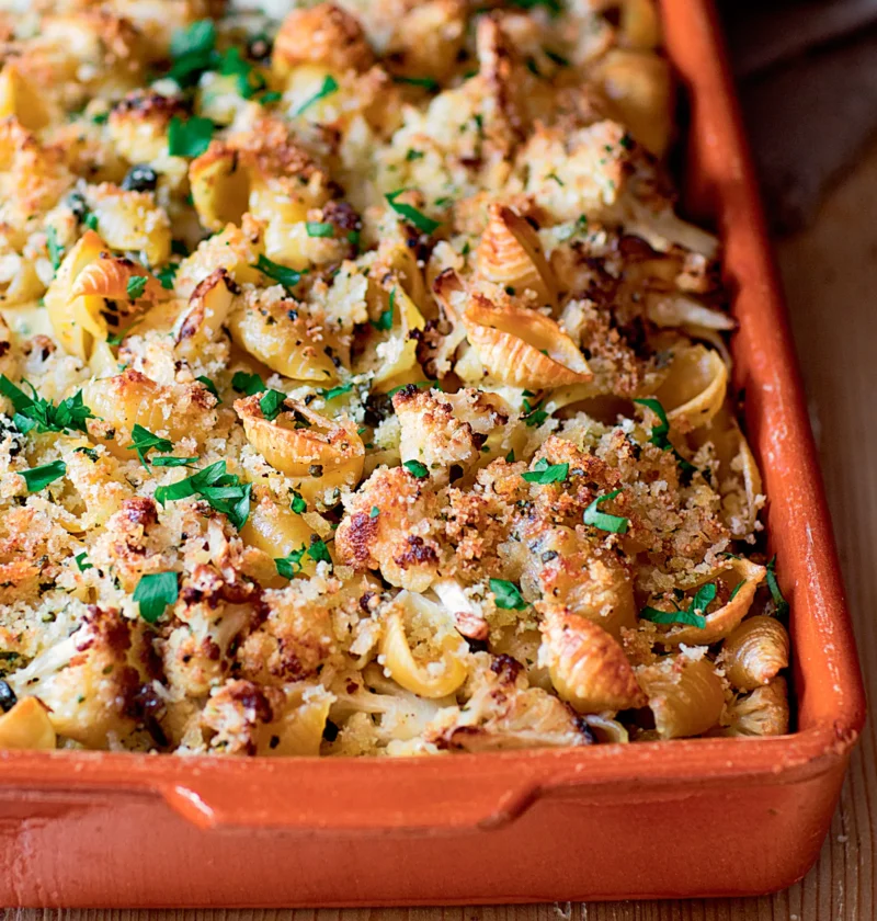 Ina Garten crusty baked shells and cauliflower in a terracotta baking dish topped with golden panko and fresh parsley