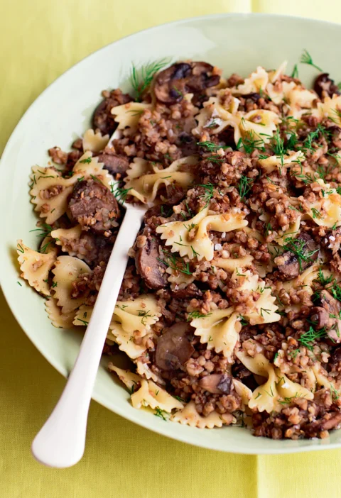 Ina Garten kasha varnishkes with wild mushrooms, bow-tie pasta and fresh dill in a pale green bowl