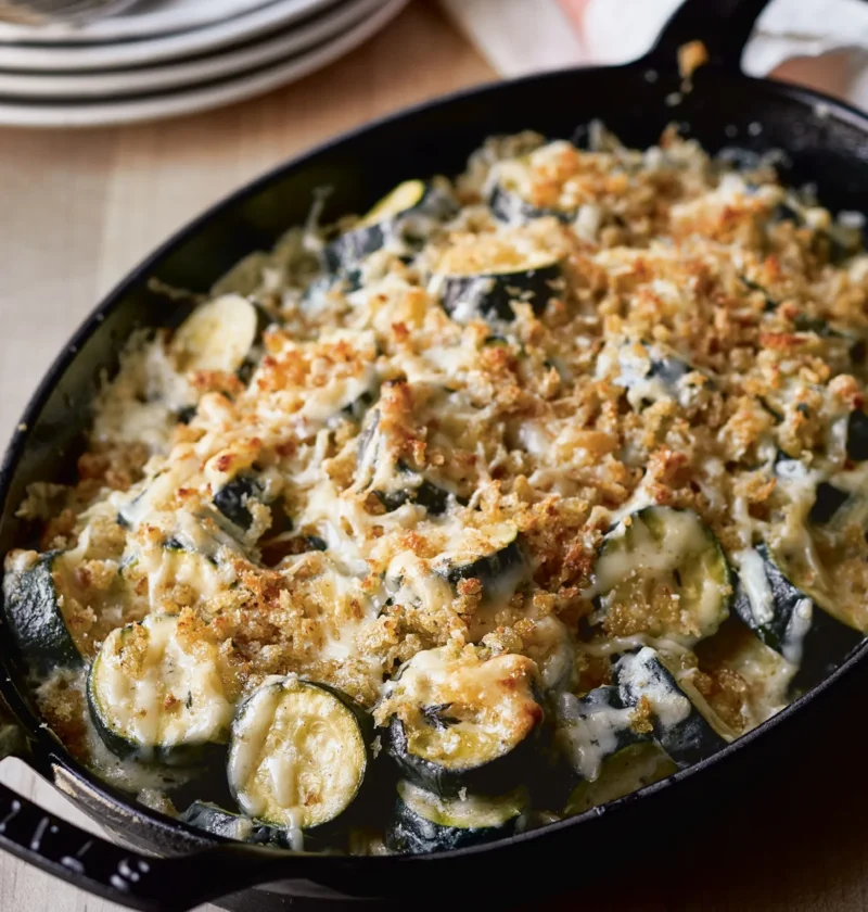 Ina Garten Provençal zucchini gratin with a golden bread crumb and Gruyère crust in a black cast iron gratin dish