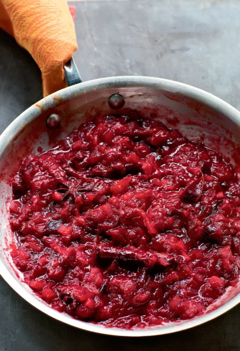 Ina Garten roasted plum chutney in a skillet with star anise and cinnamon, thick and jammy with chunks of plum and apple