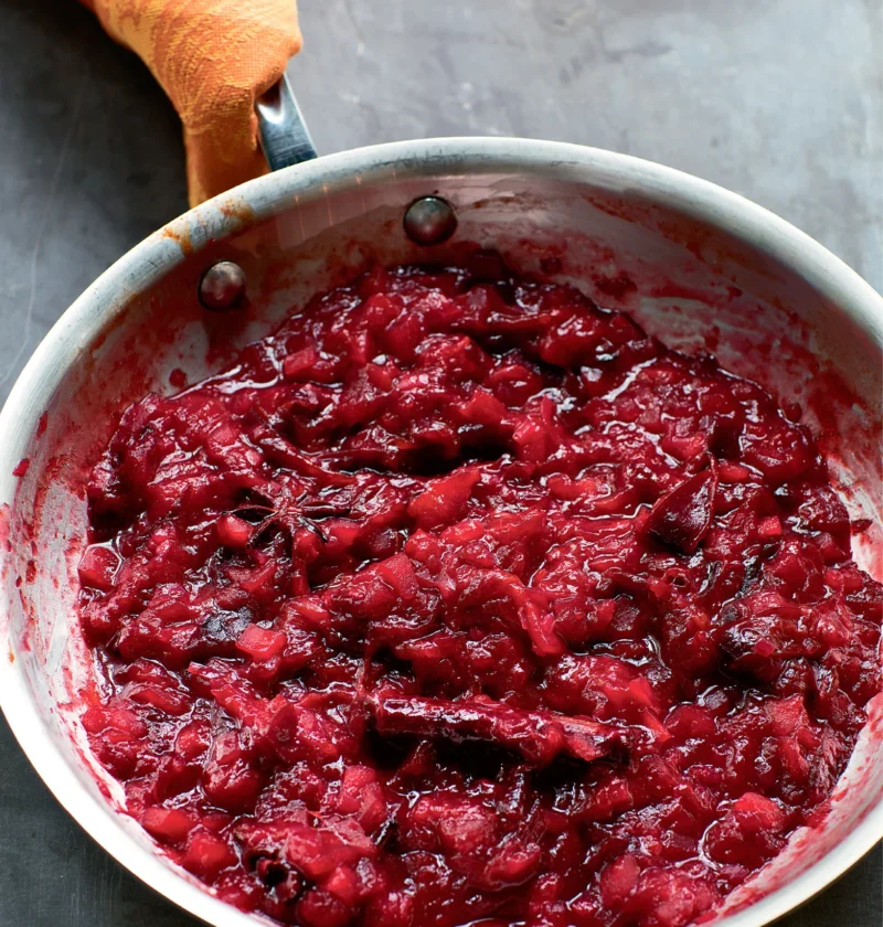 Ina Garten roasted plum chutney in a skillet with star anise and cinnamon, thick and jammy with chunks of plum and apple