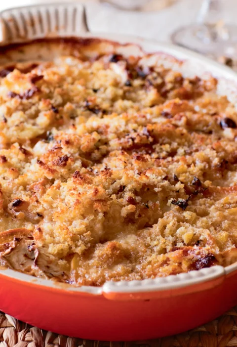 Ina Garten root vegetable gratin with a golden bread crumb crust in a red oval baking dish