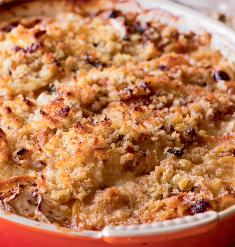 Ina Garten root vegetable gratin with a golden bread crumb crust in a red oval baking dish