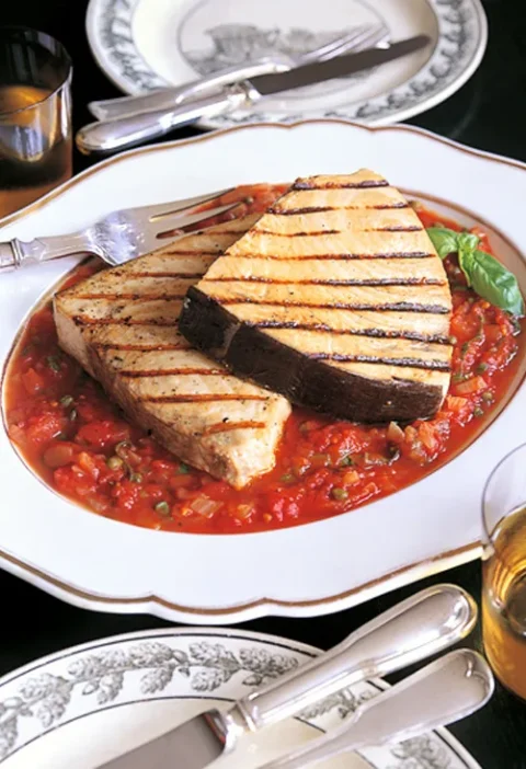 Ina Garten swordfish with tomatoes and capers, two grilled swordfish steaks on a chunky tomato sauce with fresh basil