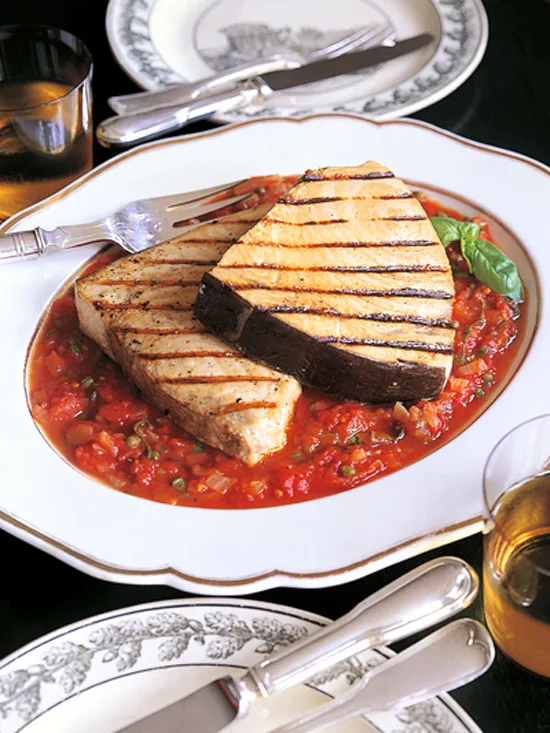 Ina Garten swordfish with tomatoes and capers, two grilled swordfish steaks on a chunky tomato sauce with fresh basil